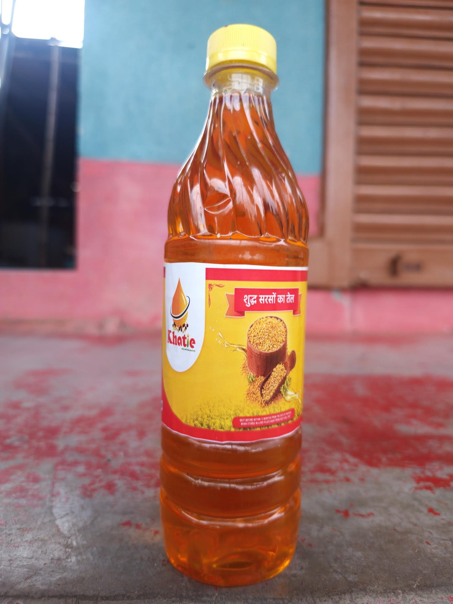 Bottle of honey with a red label on a textured surface